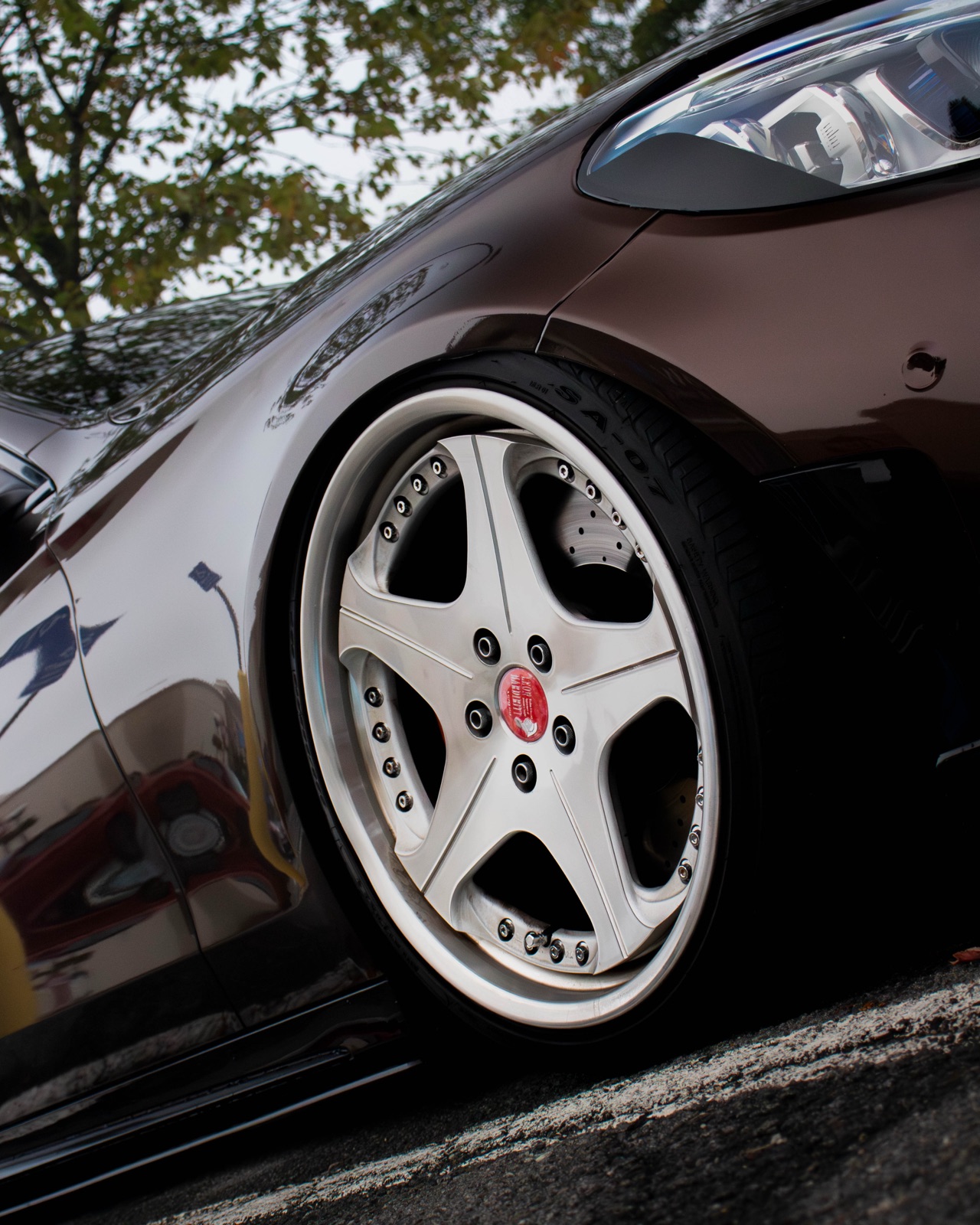 Polished multi-piece wheel detail on a lowered sedan